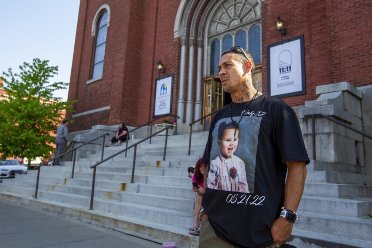 Enrique Owens, a cousin of Roberta Drury, wears a t-shirt with her photograph on it before her funeral service, Saturday, May 21, 2022, in Syracuse, N.Y. Drury was one of 10 killed during a mass shooting at a supermarket last week in Buffalo.