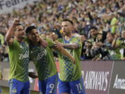 United States' Seattle Sounders forward Raul Ruidiaz (9) celebrates his goal with teammates during the second half of the second leg of the CONCACAF Champions League soccer final against Mexico's Pumas, Wednesday, May 4, 2022, in Seattle. (AP Photo/Ted S.