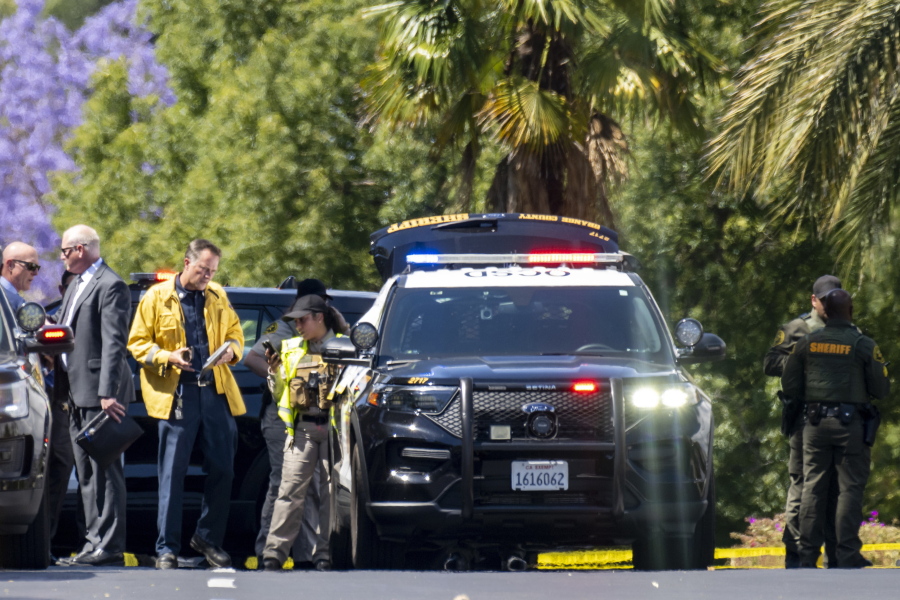 Investigators gather outside the Geneva Presbyterian Church in Laguna Woods, Calif., on Sunday, May 15, 2022 after a fatal shooting.