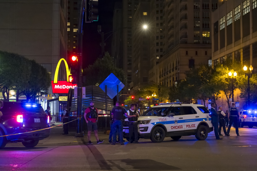 Chicago police work at the scene of a shooting near East Chicago Avenue and North State Street in the Near North Side neighborhood, Thursday, May 19, 2022 in Chicago.