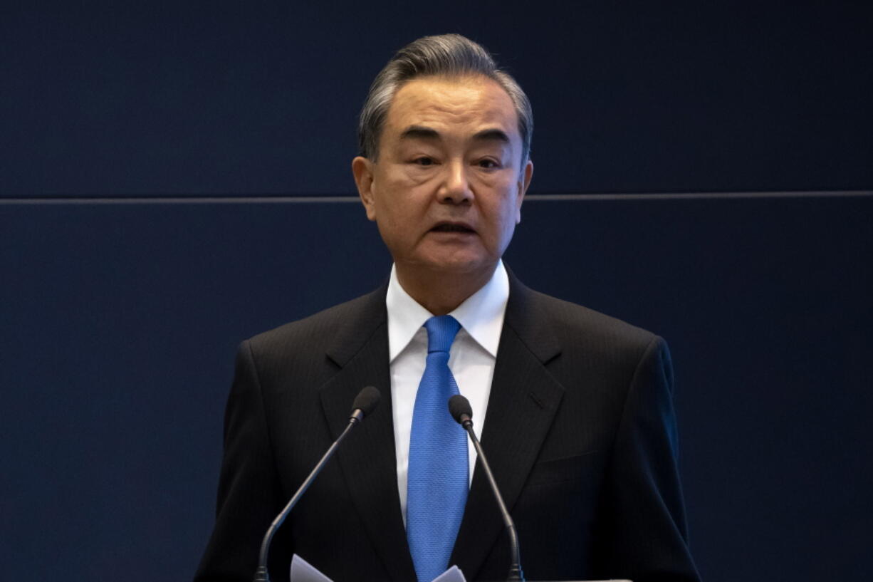 FILE - Chinese Foreign Minister Wang Yi speaks during a promotional event at the Ministry of Foreign Affairs in Beijing, Oct. 20, 2021. Wang criticized, Wednesday, May 18, 2022, what he called "negative moves" by the U.S. and Japan against China ahead of a four-way meeting in Tokyo next week of their leaders and those of India and Australia.