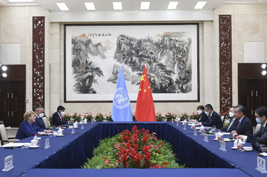 In this photo released by Xinhua News Agency, Chinese Foreign Minister Wang Yi, second right, meets with the United Nations High Commissioner for Human Rights Michelle Bachelet, left, in Guangzhou, southern China's Guangdong Province on Monday, May 23, 2022. China opposes "politicizing" human rights and imposing double standards, its foreign minister said in comments at the start of a visit by a top United Nations official focused on allegations of abuses against Muslim minorities in the northwestern region of Xinjiang.