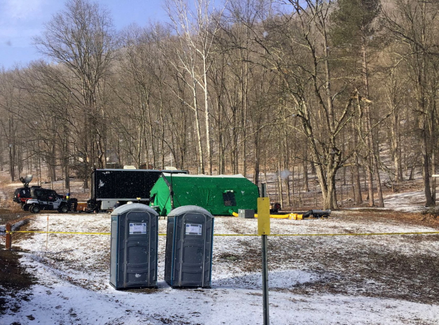FILE - FBI agents and representatives of the Pennsylvania Department of Conservation and Natural Resources set up a base in March, 2018, in Benezette Township, Elk County, Pa. A scientific report commissioned by the FBI shortly before agents went digging for buried treasure suggested that a huge quantity of gold was below the surface, according to newly released government documents.