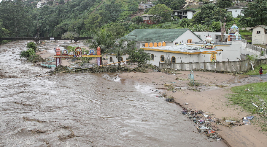 FILE - Floodwaters wash through a property near Durban, South Africa, Tuesday, April 23, 2019. The fatal floods that wreaked havoc in South Africa in mid-April this year have been attributed to climate change, an analysis published Friday, May 13, 2022 by a team of leading climate scientists said.The World Weather Attribution group analyzed both historical and emerging sets of data from the catastrophic rainfall that led to floods which triggered massive landslides in the Eastern Cape and Kwa-Zulu Natal provinces of South Africa.