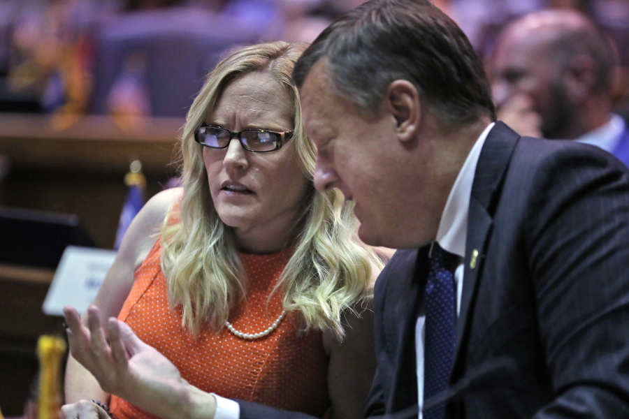 FILE - Indiana state Sen. Erin Houchin, R-Salem, left, speaks with Sen. Eric Koch, R-Bedford during a legislative hearing at the Indiana Statehouse in Indianapolis on Aug. 21, 2021. American Dream Federal Action, a super PAC financed by a cryptocurrency CEO, saturated the district with ads promoting Houchin as a "Trump Tough" conservative who would "stop the socialists in Washington." That push helped secure her win last week in a Republican primary.