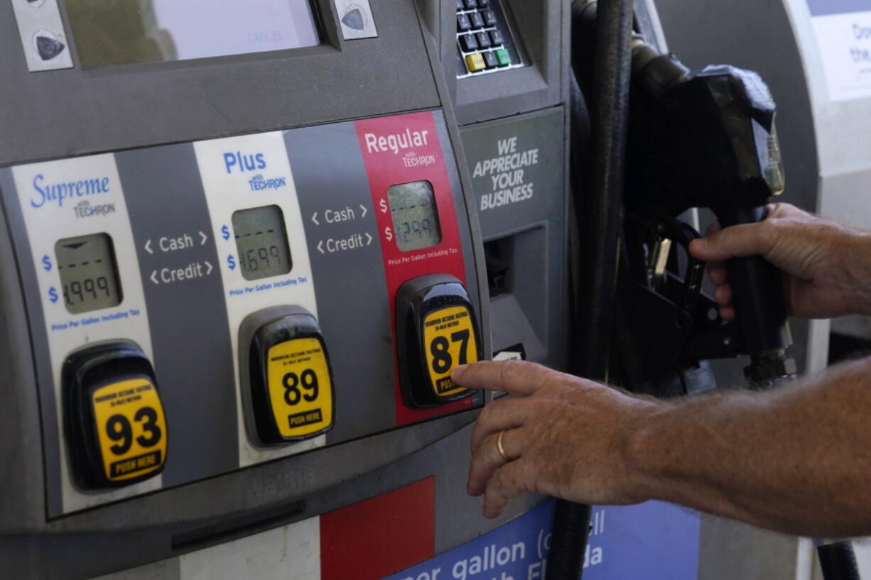 A customer pumps gas at an Exxon gas station, Tuesday, May 10, 2022, in Miami. U.S consumers have so far defied higher prices for gas, food, and rent and have been spending more in 2022, providing crucial support to the economy. How long that can continue will be one of the key factors affecting the economy and inflation this year.