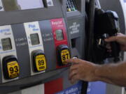 A customer pumps gas at an Exxon gas station, Tuesday, May 10, 2022, in Miami. U.S consumers have so far defied higher prices for gas, food, and rent and have been spending more in 2022, providing crucial support to the economy. How long that can continue will be one of the key factors affecting the economy and inflation this year.