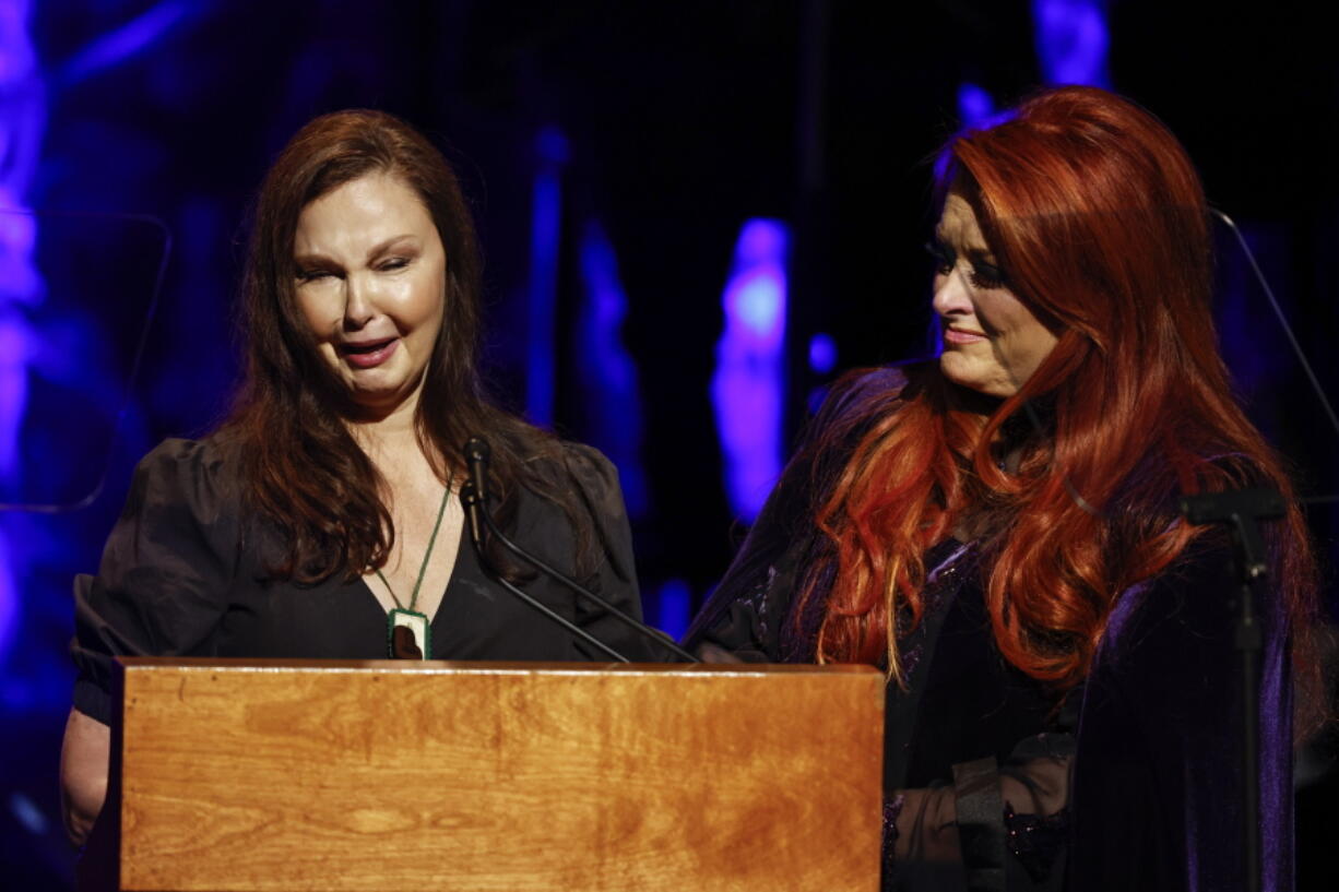 Ashley Judd, left, cries as she speaks while sister Wynonna Judd listens during the Country Music Hall of Fame Medallion Ceremony Sunday, May 1, 2022, in Nashville, Tenn.