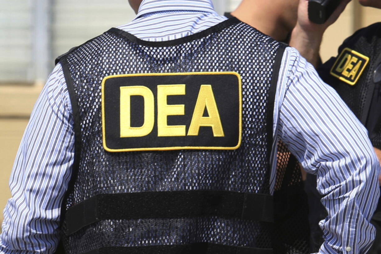 FILE - This June 13, 2016, file photo shows Drug Enforcement Administration agents in Florida.  A current U.S. Drug Enforcement Administration agent and a former supervisor in the agency were indicted Friday, May 20, 2022 on federal charges accusing them of leaking confidential law enforcement information to defense lawyers in Florida in exchange for cash and gifts.