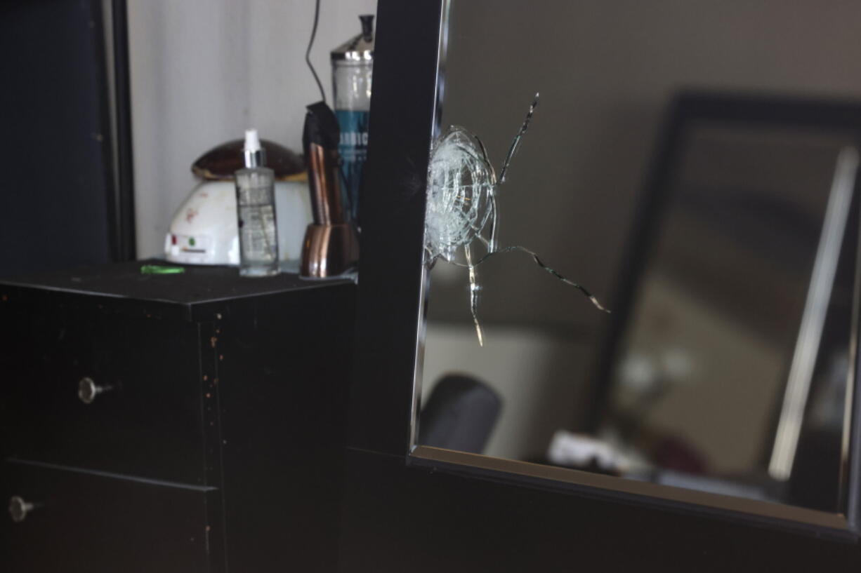 This photo shows a shattered mirror inside Hair World Salon Thursday, May 12, 2022 in Dallas. Dallas' police chief said Friday, May 13, 2022 that a shooting that injured three women in a hair salon in the city's Koreatown might have been a hate crime as he announced that it could be connected to two other shootings at businesses run by Asian Americans.