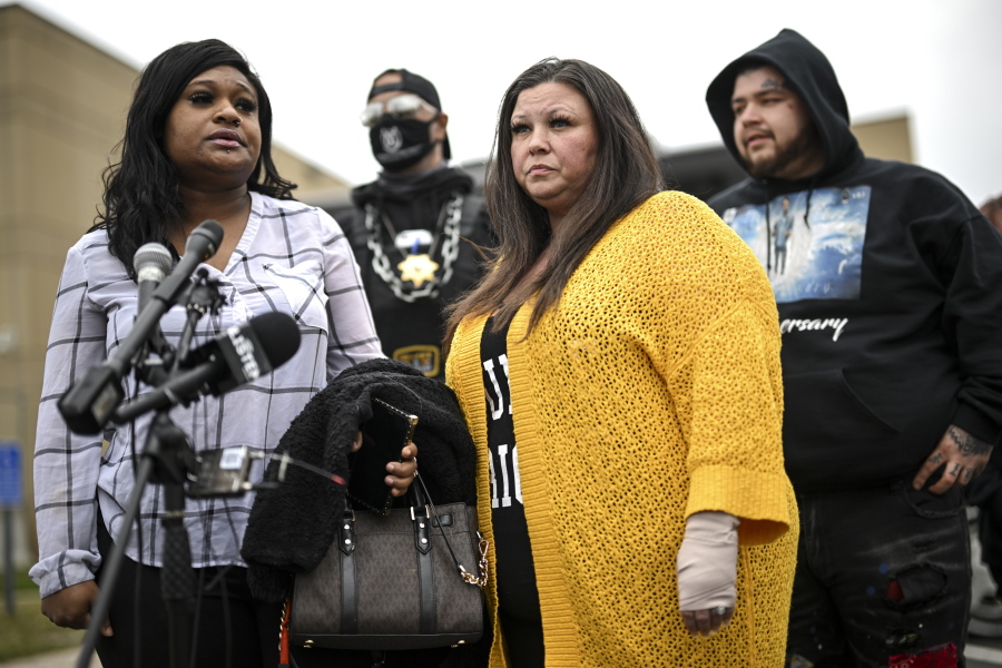 Katie Wright, center, stands beside activist Toshira Garraway and her son, Damik Bryant, during a news conference Thursday, May 5, 2022 outside the Brooklyn Center Police Station in Brooklyn Center, Minn. Katie Wright, the mother of Daunte Wright, said she was injured while she was briefly detained by one of the same department's officers after she stopped to record an arrest of a person during a traffic stop.