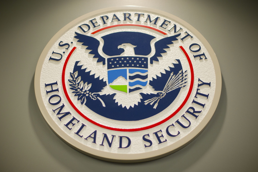 FILE - Homeland Security logo is seen during a joint news conference in Washington, Feb. 25, 2015. Nina Jankowicz, the former head of a widely criticized disinformation board, faced a torrent of sexist profanities on social media and menacing emails filled with rape or death threats. And she is not alone as women around the globe who have risen to powerful government positions have faced an overwhelming crush of online harassment, stalking and abuse.