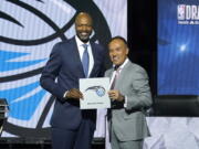 Orlando Magic head coach Jamahl Mosley, left, stands with NBA Deputy Commissioner Mark Tatum after Tatum announced that the Magic have won the first pick in the 2022 NBA draft during the NBA basketball draft lottery Tuesday, May 17, 2022, in Chicago.