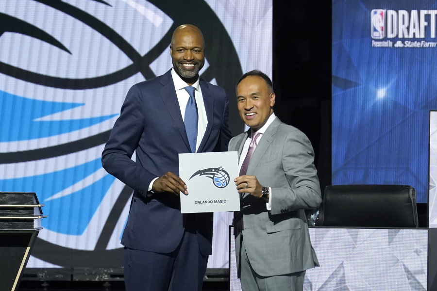 Orlando Magic head coach Jamahl Mosley, left, stands with NBA Deputy Commissioner Mark Tatum after Tatum announced that the Magic have won the first pick in the 2022 NBA draft during the NBA basketball draft lottery Tuesday, May 17, 2022, in Chicago.