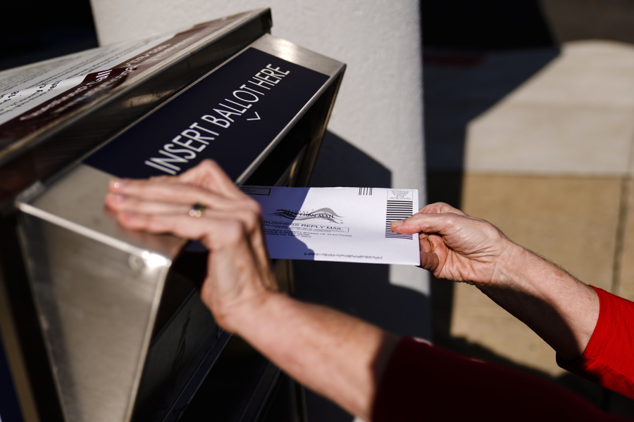 A person drops off a mail-in ballot at an election ballot return box in Willow Grove, Pa., Oct. 25, 2021. On Tuesday, May 3, 2022, The Associated Press reported on a film that used a flawed analysis of cellphone location data and ballot drop box surveillance footage to cast doubt on the results of the 2020 presidential election.