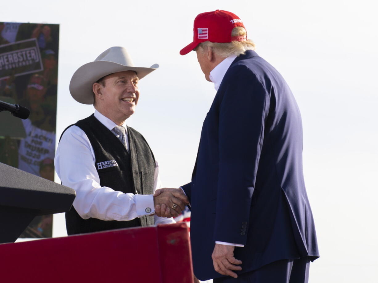 FILE - Nebraska Republican gubernatorial candidate Charles Herbster, left, shakes hands with former President Donald Trump during a campaign rally for Herbster, May 1, 2022, in Greenwood, Neb. Nebraska Nebraska Republicans will pick a nominee for governor on Tuesday, May 10, to replace Republican Gov. Pete Ricketts, who's prevented by term limit laws from running again.