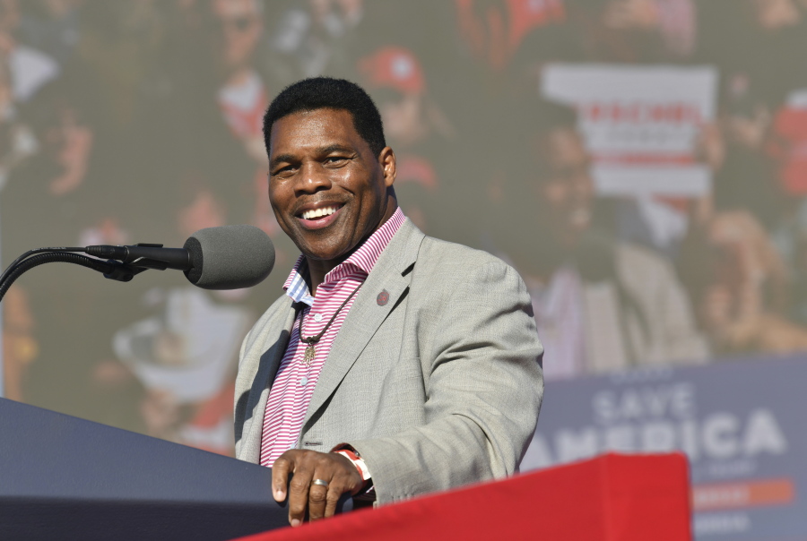 FILE - Herschel Walker, front-runner for the party's U.S. Senate nominee, speaks during a rally for Georgia GOP candidates at Banks County Dragway in Commerce, Ga., Saturday, March 26, 2022. In his run for U.S. Senate in Georgia, former football great Herschel Walker has gone to great lengths so far to dodge tough questions. The GOP candidate does not widely publicize his campaign stops and limits his appearances mostly to conservative news outlets and friendly audiences. Earlier this month, he skipped the first debate for the May 24 Republican primary.