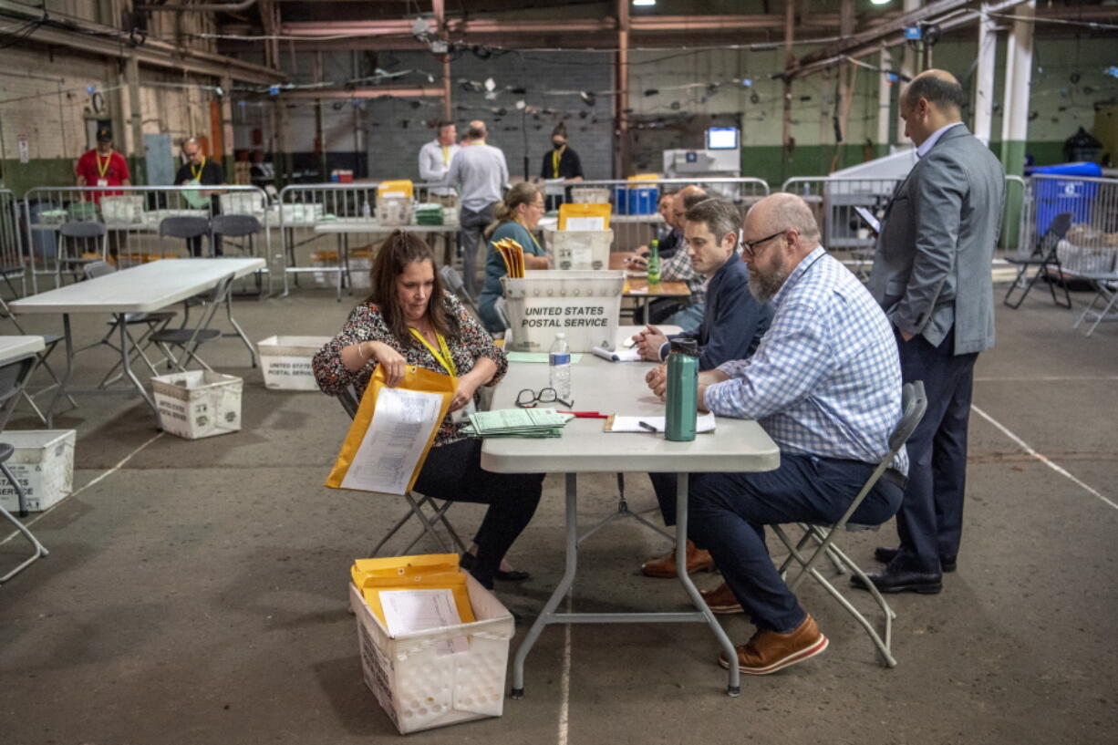 Allegheny County elections workers review provisional ballots with authorized representatives from Dave McCormick and Dr. Mehmet Oz's campaigns, Monday, May 23, 2022, on the North Side neighborhood of Pittsburgh, Pa.