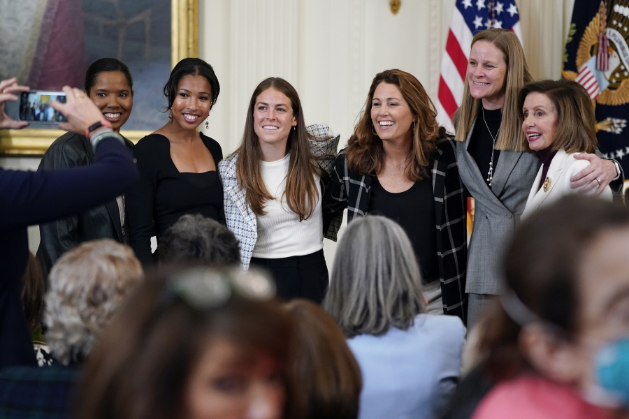 Former members and members of the U.S. Women's National soccer team, from left,  Briana Scurry, Margaret 'Midge' Purce, Kelley O'Hara, Julie Foudy, and Cindy Parlow Cone, President of U.S. Soccer, pose for a photo with House Speaker Nancy Pelosi of Calif., before an event to celebrate Equal Pay Day and Women's History Month in the East Room of the White House, Tuesday, March 15, 2022, in Washington. The U.S. Soccer Federation reached milestone agreements to pay its men's and women's teams equally, making the American national governing body the first in the sport to promise both sexes matching money.