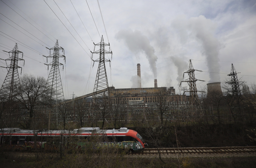 A train passes by Republika Power Plant in town of Pernik, Bulgaria, Thursday, April 21, 2022. The only nuclear power plant, generating over a third of Bulgaria's electricity, runs on uranium from Russia.