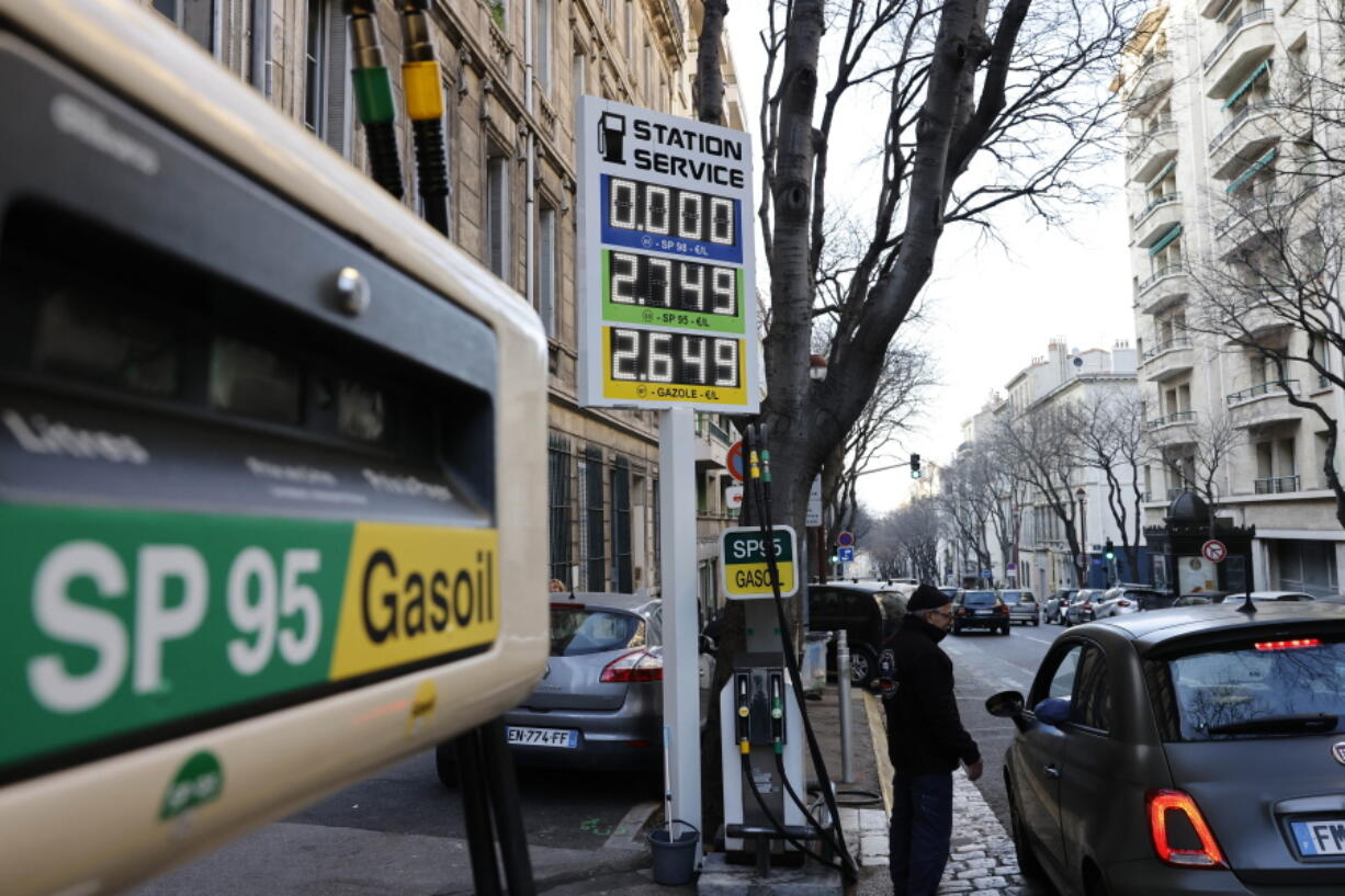 FILE - A car stops in a gas station where prices are up to 2,75 euros per liter (US dlrs. 3.04) in Marseille, southern France, Wednesday, March 9, 2022. The European Union slashed its forecasts of economic growth in the 27-nation bloc amid the prospect of a drawn-out Russian war in Ukraine and disruptions to EU energy trade. EU imports of energy from Russia last year totaled 99 billion euros ($103 billion), or 62% of the bloc's purchases of Russian goods. Russia is the top supplier to the EU of oil, natural gas and coal, accounting for around a quarter of the bloc's total energy.