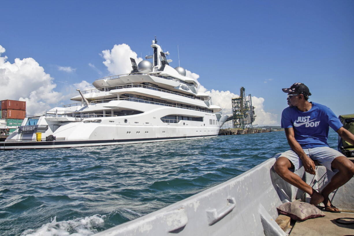 FILE - Boat captain Emosi Dawai looks at the superyacht Amadea where it is docked at the Queens Wharf in Lautoka, Fiji, on April 13, 2022. The superyacht that American authorities say is owned by a Russian oligarch previously sanctioned for alleged money laundering has been seized by law enforcement in Fiji, the U.S. Justice Department announced Thursday, May 5.
