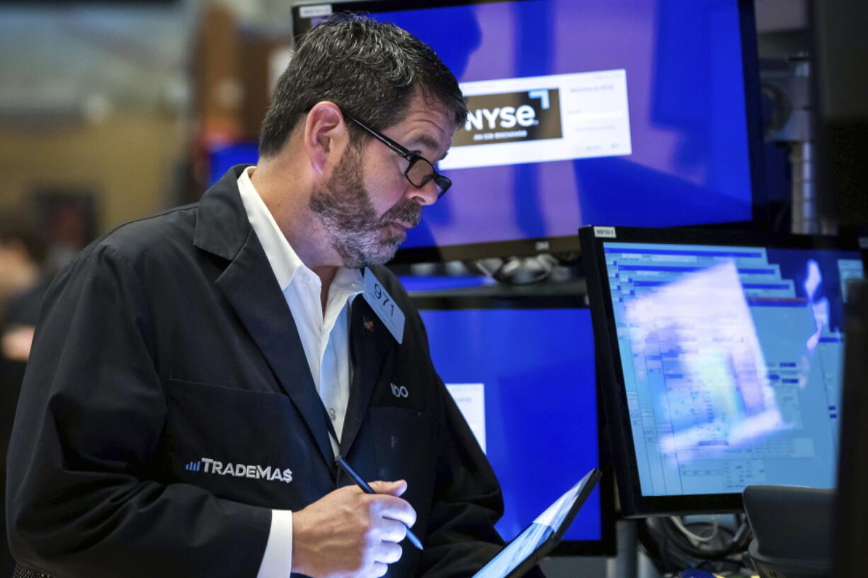 In this photo provided by the New York Stock Exchange, trader James MacGilvray works on the floor, Friday, May 13, 2022. Stocks rallied on Wall Street Friday, but not enough to claw back all the losses the market has taken in this volatile week of trading.