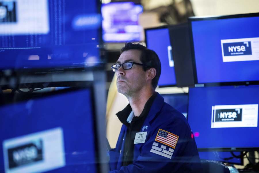 In this photo provided by the New York Stock Exchange, specialist John McNierney works at his post on the floor, Friday, May 27, 2022, in New York. Stocks rose in morning trading on Wall Street Friday, keeping the market on track for its first weekly gain after seven weeks of losses.