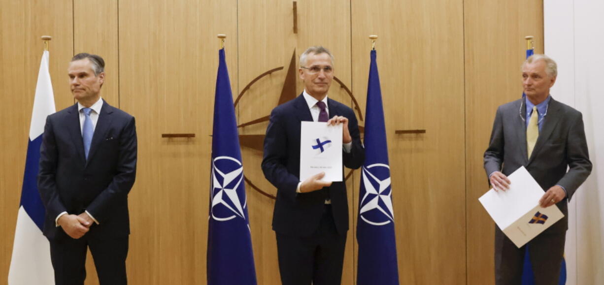 Finland's Ambassador to NATO Klaus Korhonen, NATO Secretary-General Jens Stoltenberg and Sweden's Ambassador to NATO Axel Wernhoff attend a ceremony to mark Sweden's and Finland's application for membership in Brussels, Belgium, Wednesday May 18, 2022. NATO Secretary-General Jens Stoltenberg said that the military alliance stands ready to seize a historic moment and move quickly on allowing Finland and Sweden to join its ranks, after the two countries submitted their membership requests.