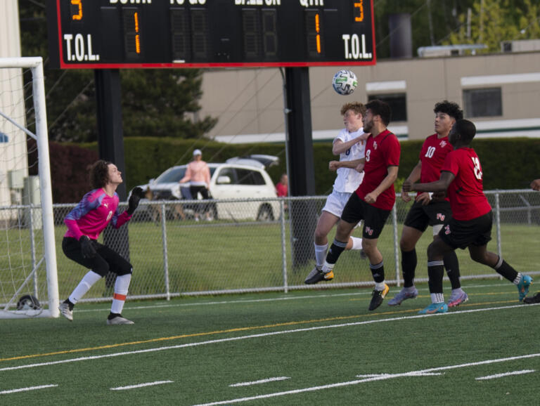 Fort Vancouver's Roberto Revuelta (9) heads the ball into the goal in the first half during the Trappers' 2-0 win over Ridgefield in 2A boys soccer district playoff on Saturday, May 14, 2022.
