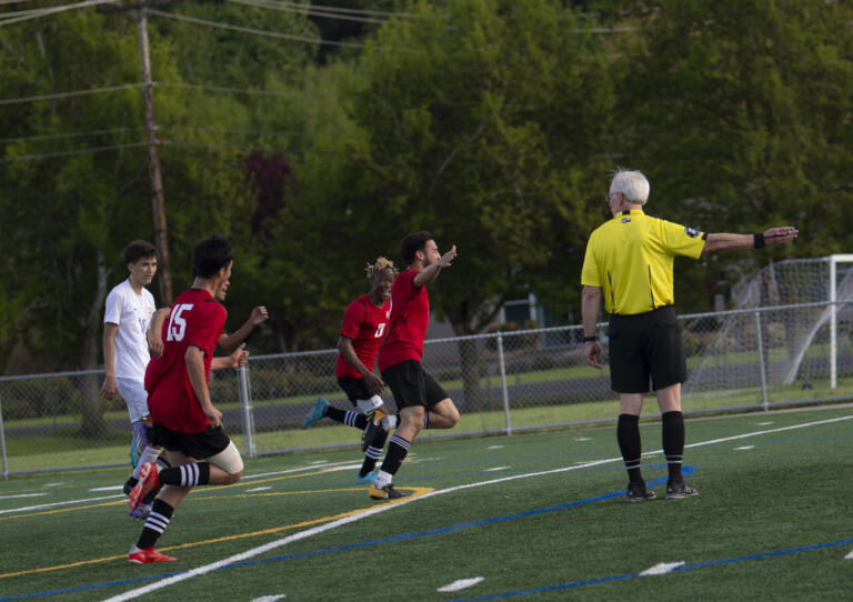 Fort Vancouver's Roberto Revuelta celebrates his first-half goal during the Trappers' 2-0 win over Ridgefield in 2A boys soccer district playoff on Saturday, May 14, 2022.