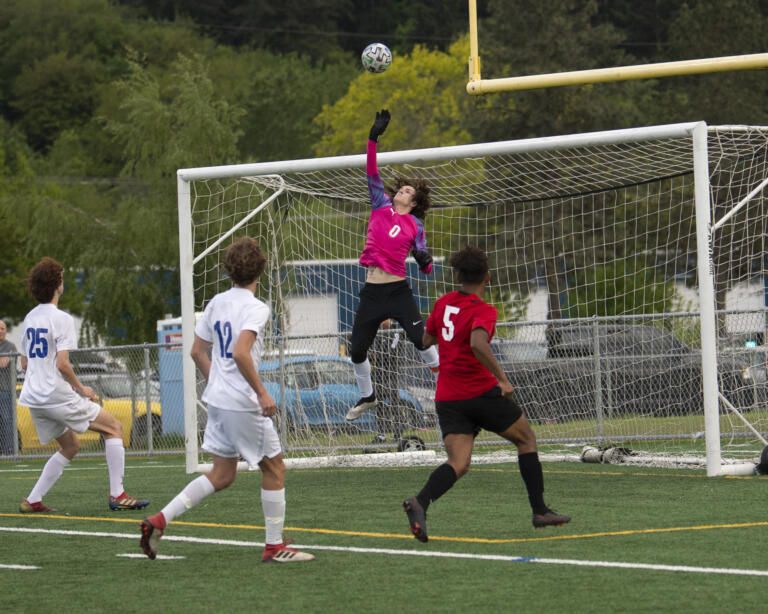 Ridgefield goalkeeper Jace Wilson (0) deflects a shot over the goal during the Trappers' 2-0 win over Ridgefield in 2A boys soccer district playoff on Saturday, May 14, 2022.