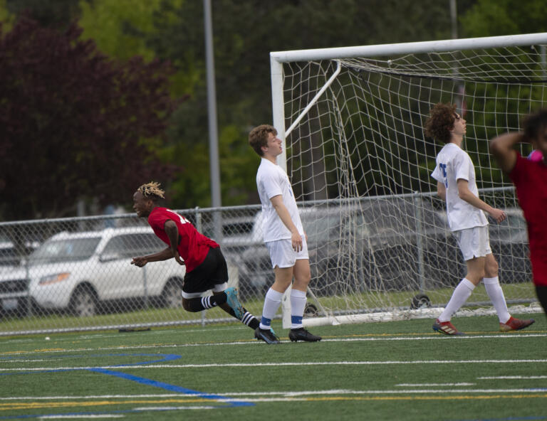 Fort Vancouver's Morlai Sesay celebrates his second-half goal during the Trappers' 2-0 win over Ridgefield in 2A boys soccer district playoff on Saturday, May 14, 2022.