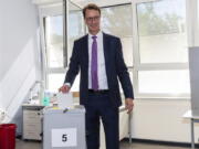 Hendrik Wuest (CDU), Minister President of North Rhine-Westphalia, stands in the polling station and puts his ballot paper into the ballot box in Rhede, Germany, Sunday, May 15, 2022.. The election for the 18th state parliament takes place in North Rhine-Westphalia on Sunday. Around 13.2 million people are called to the polls.