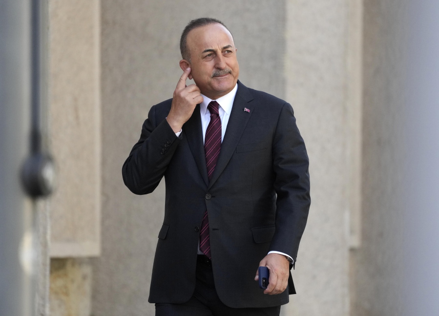 Turkish Foreign Minister Mevlut Cavusoglu scratches his head during an informal meeting of the North Atlantic Council in Foreign Ministers' session in Berlin, Germany, Sunday, May 15, 2022.