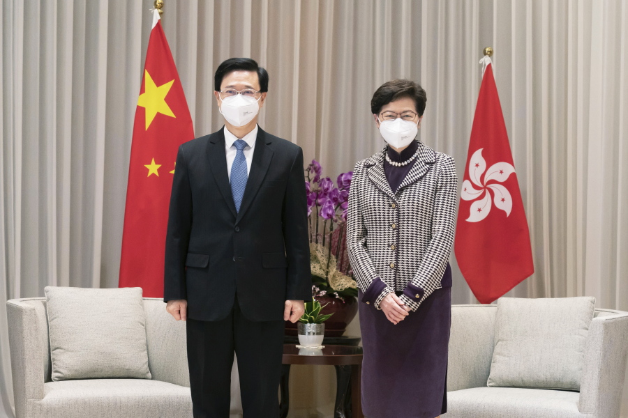 Hong Kong Chief Executive-elect John Lee, left, and Chief Executive Carrie Lam pose for a photo during a meeting at the Central Government Complex ahead of a news conference in Hong Kong, Monday, May 9, 2022.