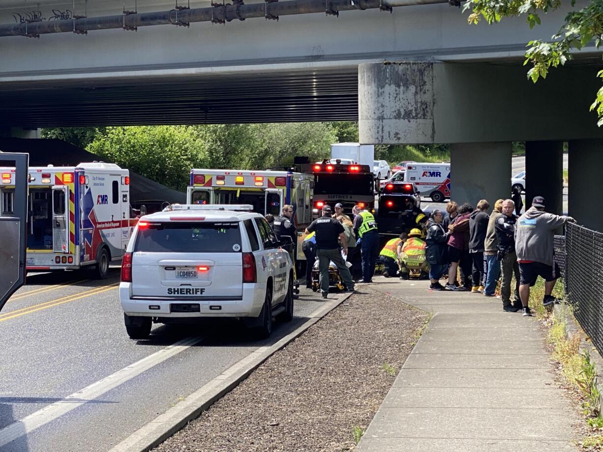 Fire District 6 and AMR treat an injured passenger from a Salmon Creek crash on Thursday afternoon. The vehicle went down the embankment and into the water.