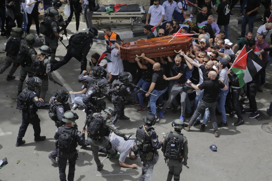 FILE - Israeli police confront mourners as they carry the casket of slain Al Jazeera veteran journalist Shireen Abu Akleh during her funeral in east Jerusalem, Friday, May 13, 2022. Latin Patriarch Pierbattista Pizzaballa, the top Catholic clergyman in the Holy Land, told reporters at St. Joseph Hospital in Jerusalem on Monday that the police beating mourners as they carried Shireen Abu Akleh's her casket was a disproportionate use of force that "disrespected" the Catholic Church. He added that Israel committed a "severe violation" of international norms.