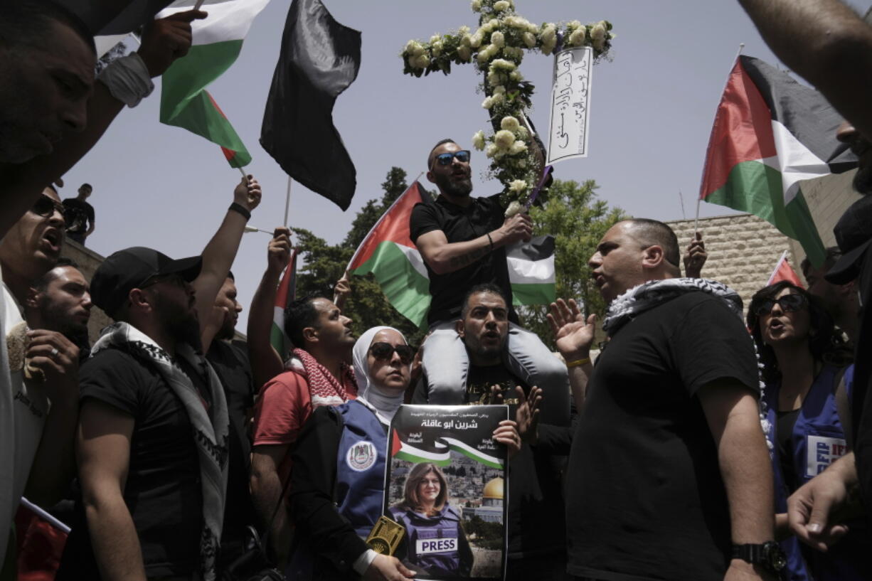 Mourners gather at the hospital where the body of slain Al Jazeera veteran journalist Shireen Abu Akleh will be taken from to to her final resting place, in east Jerusalem, Friday, May 13, 2022.