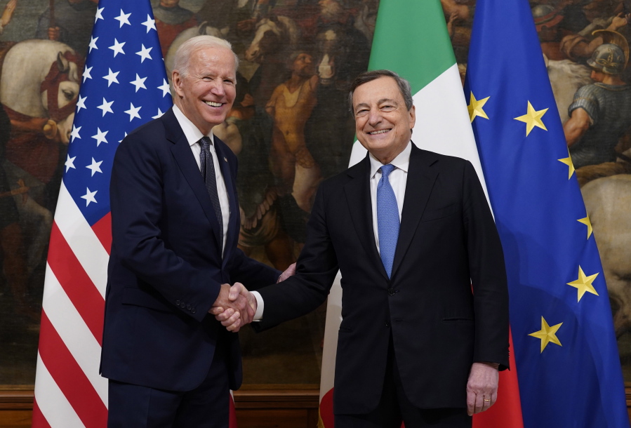 FILE - U.S. President Joe Biden, left, shakes hands with Italy's Prime Minister Mario Draghi prior to a ceremony at the Chigi Palace in Rome, Friday, Oct. 29, 2021. Italian Premier Mario Draghi meets with U.S. President Biden this week in Washington, D.C., as Europe faces another "whatever it takes" moment, with war raging on its eastern flank in Ukraine.