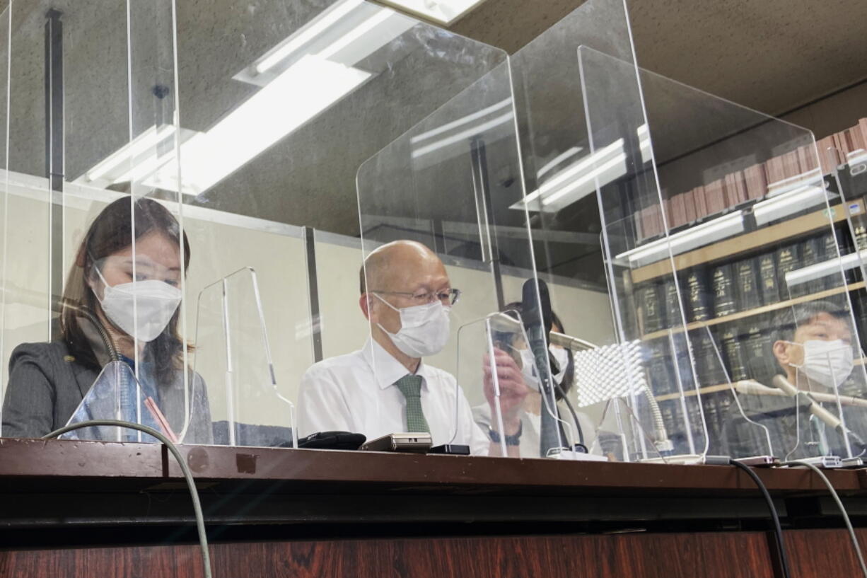 Lawyer Kenichi Ido, second left, sitting among other lawyers representing plaintiffs who were children in Fukushima at the time of the 2011 nuclear disaster and later developed thyroid cancer, speaks during a news conference after a trial in Tokyo, Thursday, May 26, 2022. A Tokyo court began hearing a case Thursday seeking nearly $5 million in damages for six people who lived as children in Fukushima and developed thyroid cancer after its 2011 nuclear disaster.