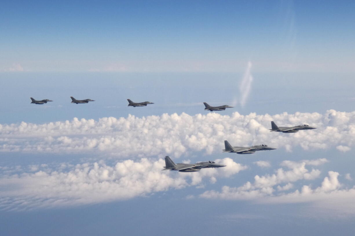 In this photo provided by the Joint Staff of the Japanese Self-Defense Force, three F-15 warplanes of the Japanese Self-Defense Force, front, and four F-16 fighters of the U.S. Armed Forces fly over the Sea of Japan on Wednesday, May 25, 2022. Japanese and U.S. forces conducted the joint fighter jet flight over the Sea of Japan, Japan's Defense Ministry said Thursday, in an apparent response to a Russia-China joint bomber flight while U.S. President Joe Biden was in Tokyo.