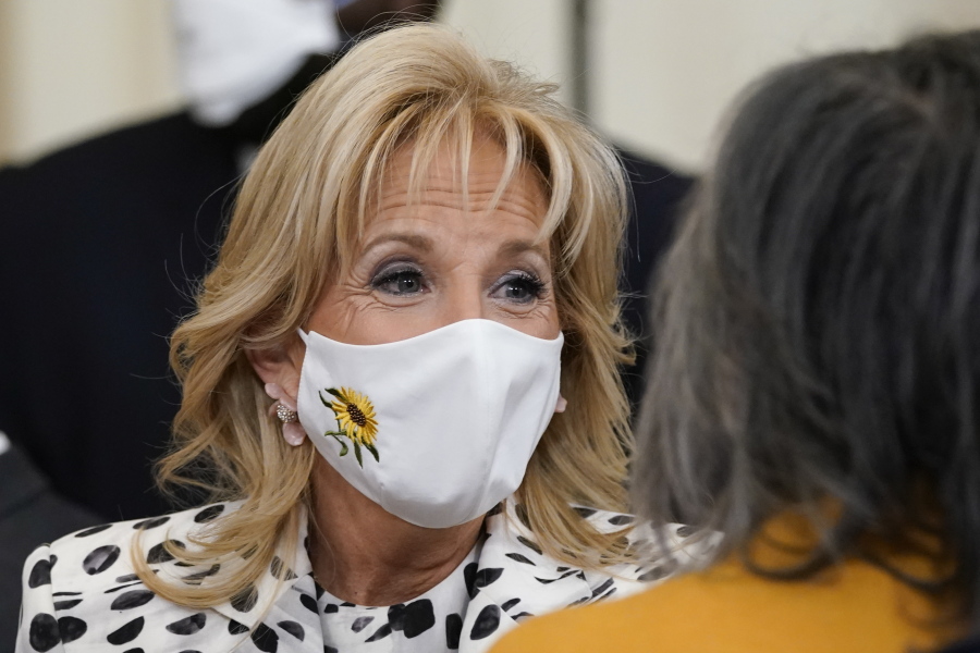 FILE - First lady Jill Biden wears a mask with a sunflower, the national flower of Ukraine, in support of the Ukrainian people at an event to celebrate Black History Month in the East Room of the White House, Feb. 28, 2022, in Washington. The White House has announced that Jill Biden will meet with Ukrainian refugees during a trip to Romania and Slovakia later this week. The first lady will visit both eastern European countries during a five-day trip that starts Thursday. Romania and Slovakia share borders with Ukraine.