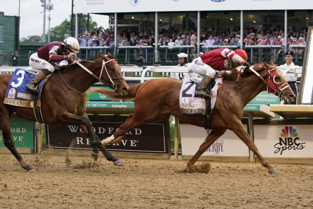 Rich Strike (21), with Sonny Leon aboard, beats Epicenter (3), with Joel Rosario aboard, at the finish line to win the 148th running of the Kentucky Derby horse race at Churchill Downs Saturday, May 7, 2022, in Louisville, Ky.