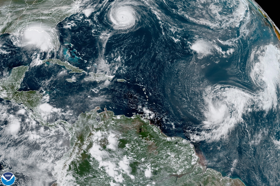 Five tropical storms churn in the Atlantic basin on Monday, Sept. 14, 2020. A NOAA study released Wednesday says cleaner air in Europe and the United States is helping trigger an increase in the number of Atlantic hurricanes.