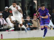 Inter Miami midfielder Gregore, left, runs with the ball as Portland Timbers defender Justin Rasmussen gives chase during the second half of an MLS soccer match, Saturday, May 28, 2022, in Fort Lauderdale, Fla. Inter Miami won 2-1.