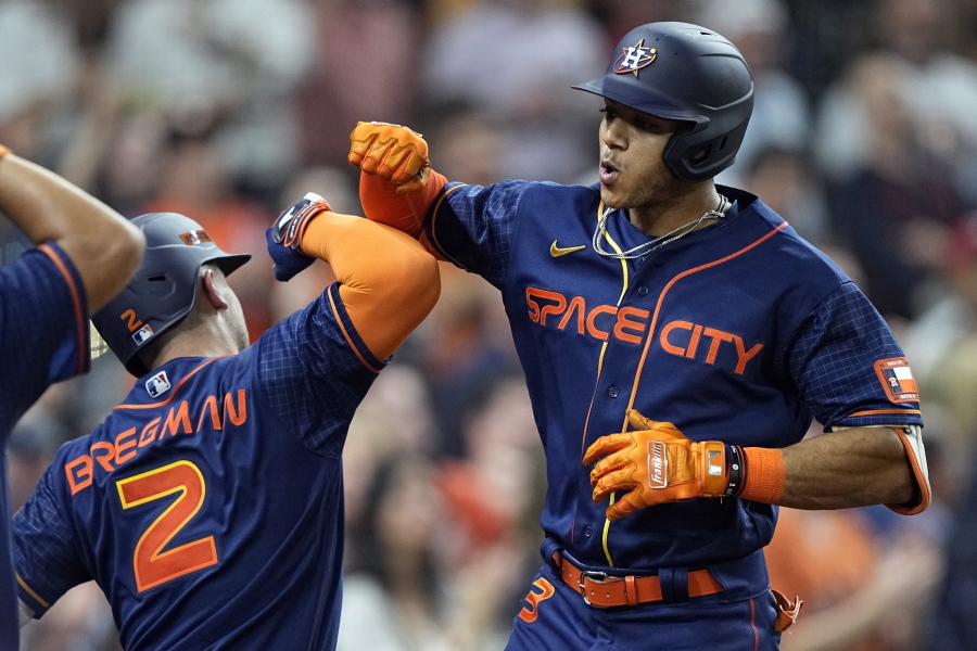 Houston Astros' Jeremy Pena (3) celebrates with Alex Bregman (2) after hitting a two-run home run against the Seattle Mariners during the sixth inning of a baseball game Monday, May 2, 2022, in Houston. (AP Photo/David J.