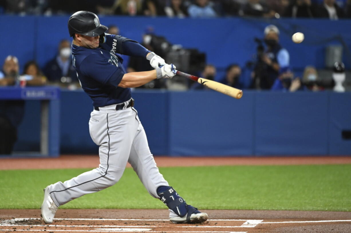 Seattle Mariners' Ty France hits a single during the first inning of a baseball game against the Toronto Blue Jays in Toronto on Wednesday, May 18, 2022.