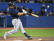Seattle Mariners' Ty France hits a single during the first inning of a baseball game against the Toronto Blue Jays in Toronto on Wednesday, May 18, 2022.