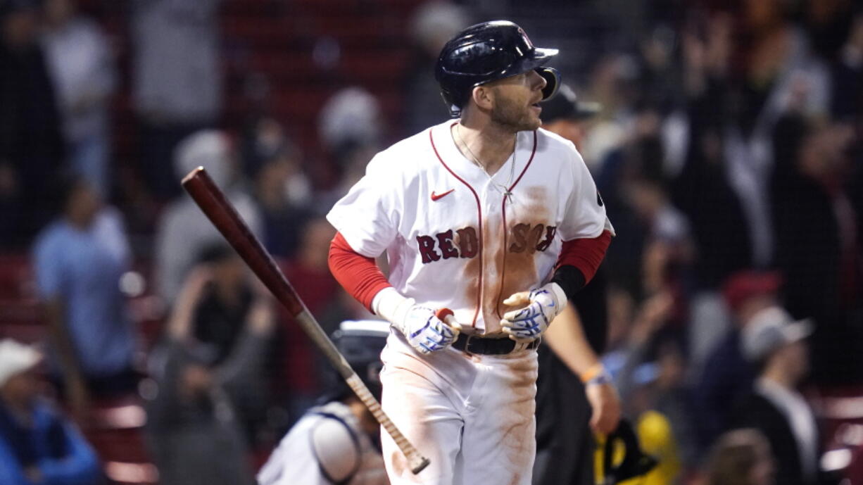 Boston Red Sox's Trevor Story tosses his bat while watching his three-run home run against the Seattle Mariners during the eighth inning of a baseball game at Fenway Park, Thursday, May 19, 2022, in Boston. Story hit two two-run home runs earlier in the game.